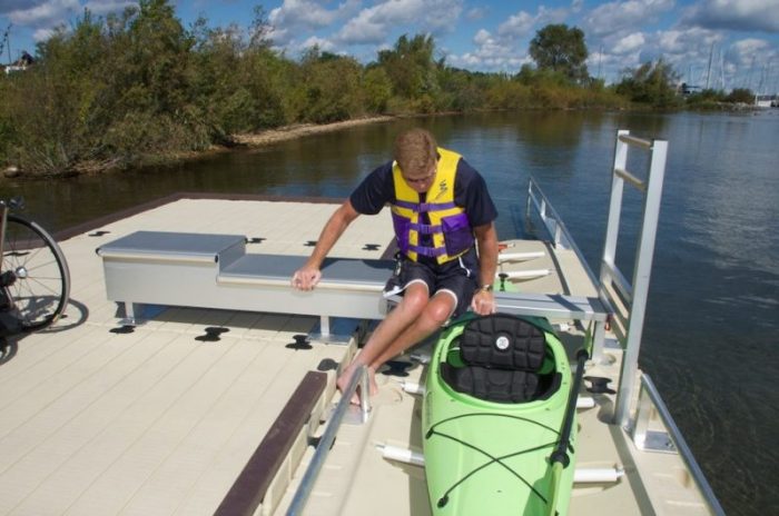 Disabled kayak user using ez launch transfer bench to access kayak